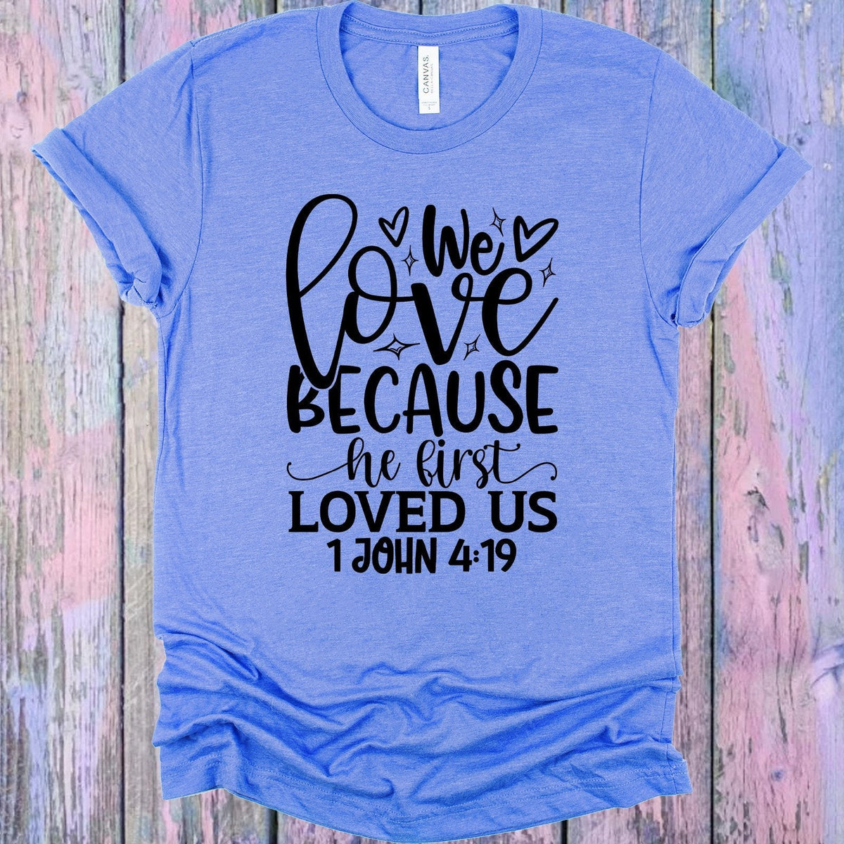 We Love Because He First Loved Us Graphic Tee product image 1
